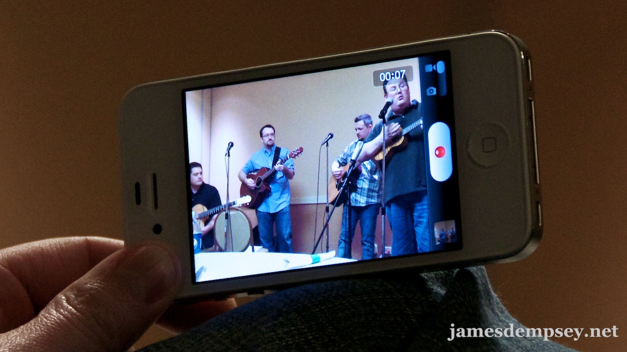 A video of the band being recorded on an iPhone screen