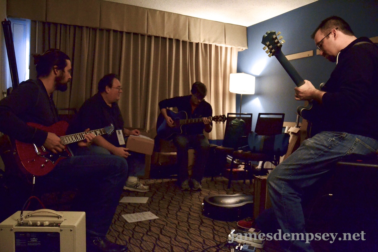 Rusty Zarse, James Dempsey, Jonathan Penn and Brandon Alexander rehearse while sitting in a circle in a small room