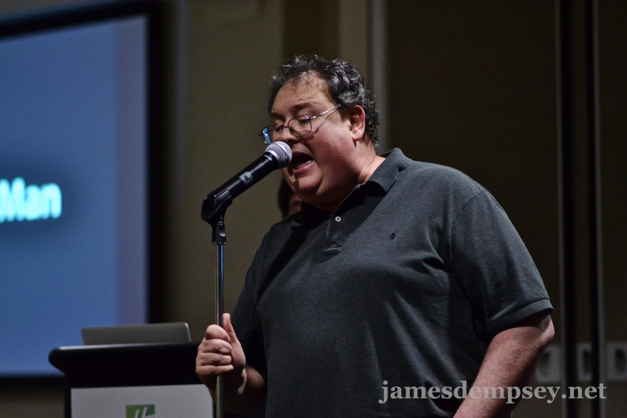 James Dempsey singing into microphone