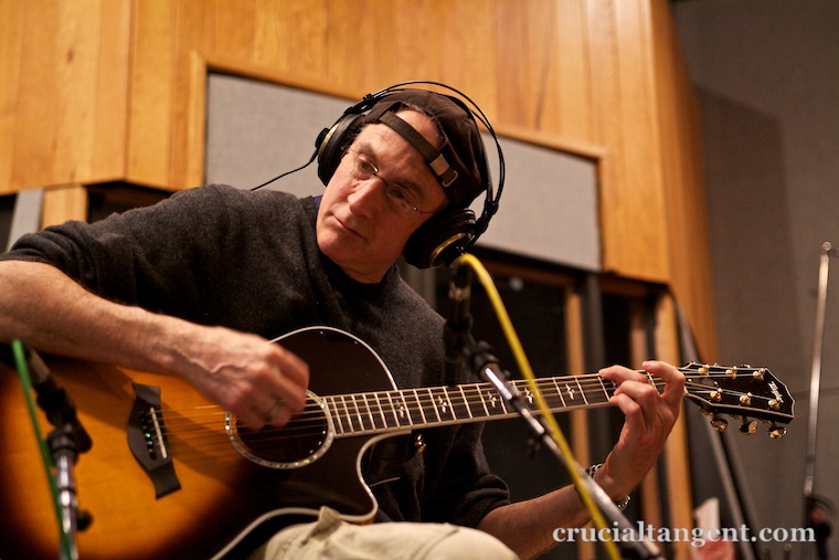 Gordie Freedman playing guitar in the studio
