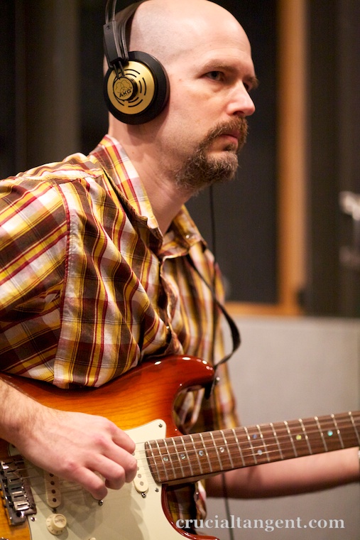 John Scalo playing electric guitar in the studio