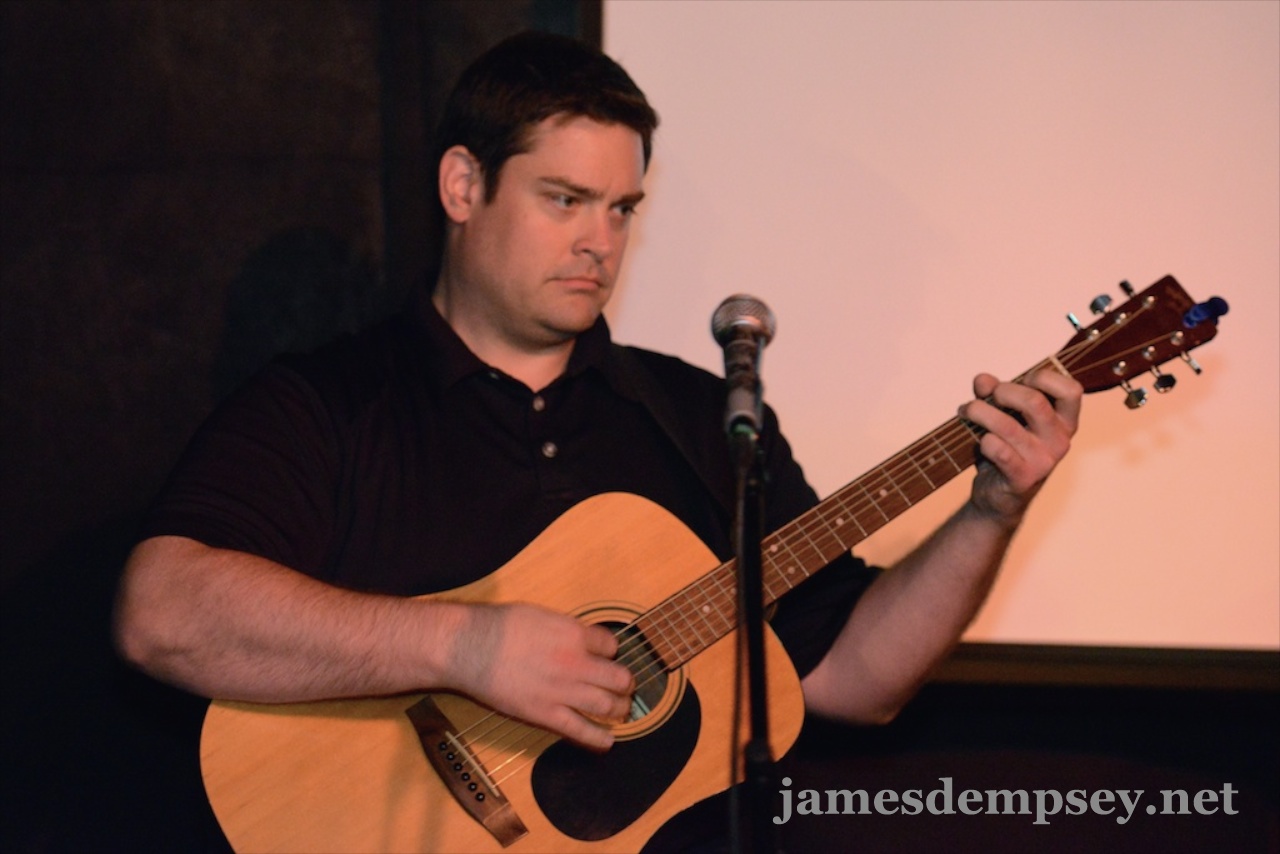Nathan Eror playing acoustic guitar