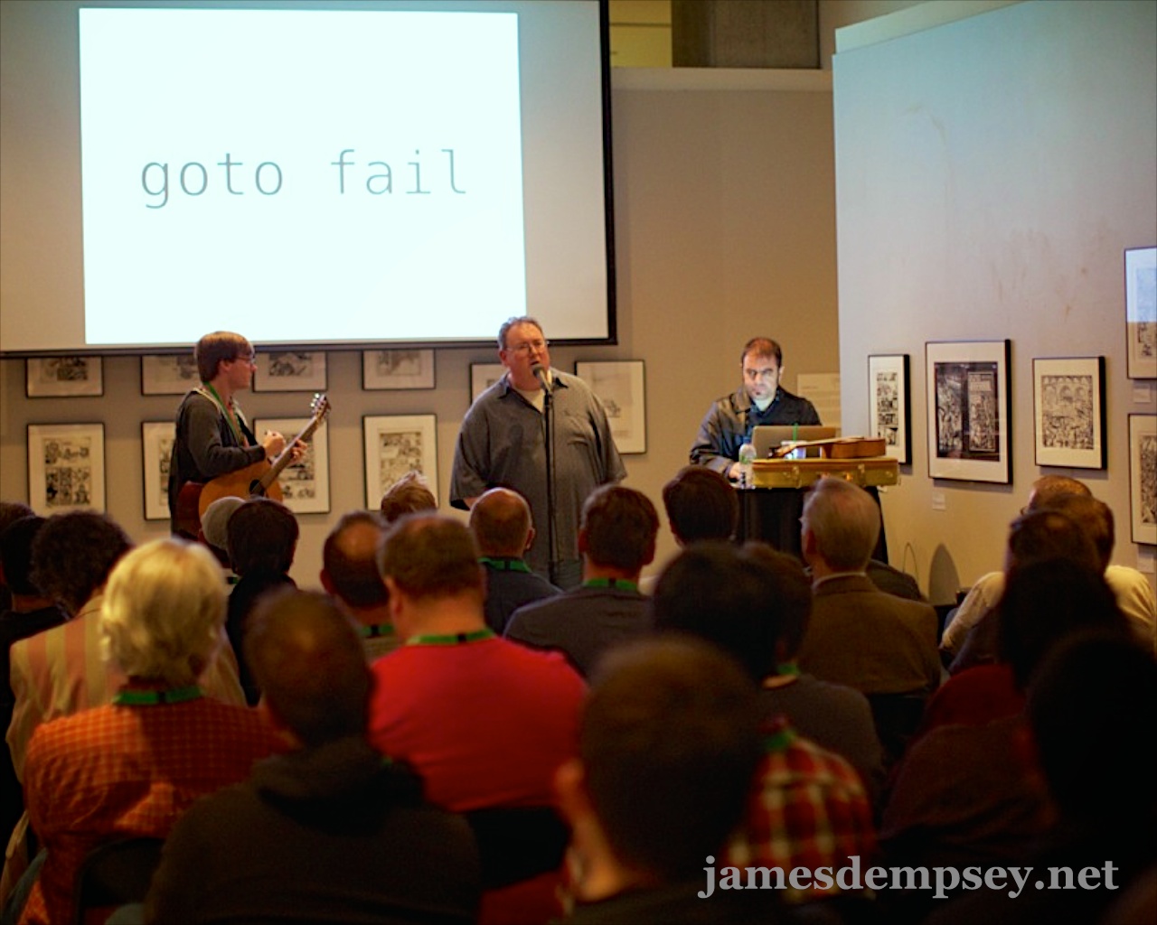 Jonathan Penn playing acoustic guitar, James Dempsey singing and Victor Alexander on slide advance keyboard perform at the Cartoon Art Museum