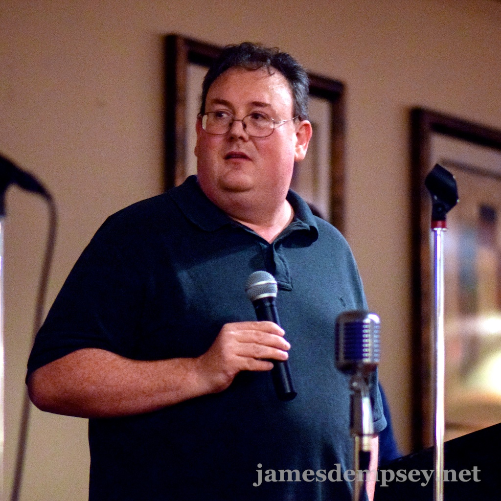James Dempsey holding a wireless microphone